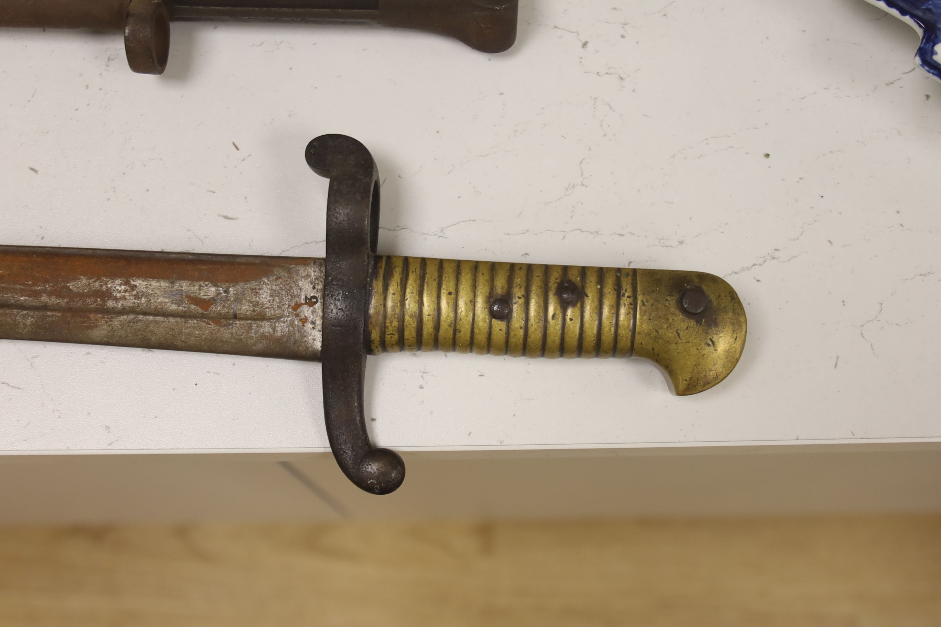 A 19th century French bayonet, together with an early 20th century English bayonet and a ‘Remember The Alamo 1836 The Stand of Colonel Jim' Bowie knife